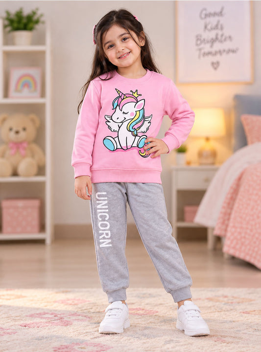 Girl wearing pink unicorn winter tracksuit with grey joggers