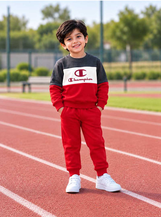Boy wearing red and charcoal winter tracksuit