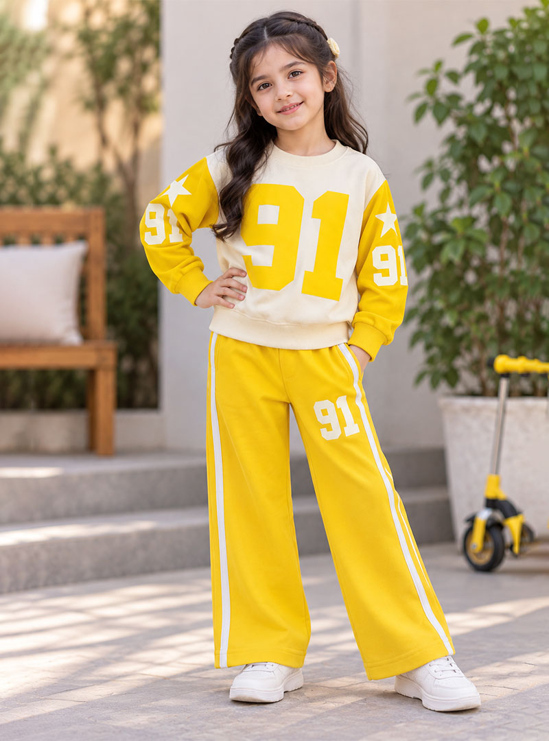 Girl wearing cream and yellow 91 printed winter tracksuit set