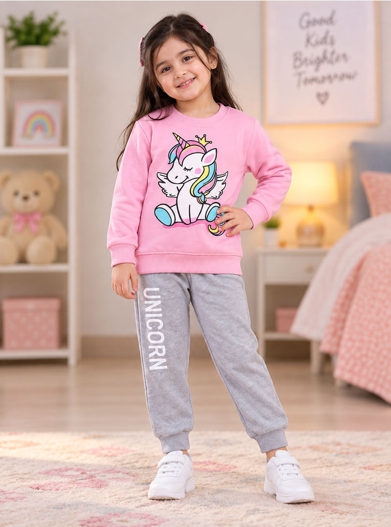 Girl wearing pink unicorn winter tracksuit with grey joggers